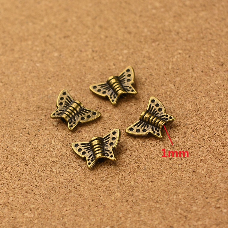 Трговија на големо гроздобер 200pcs антички бронза Пеперутка мала дупка мушка шарм diy накит Наоди 1.5 mm hola кол